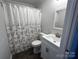 Recently renovated bathroom with modern fixtures, sleek vanity, and a shower with a floral shower curtain at 424 20Th Ne Ave, Hickory, NC 28601