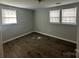 This bedroom features two windows and wood-look flooring at 424 20Th Ne Ave, Hickory, NC 28601