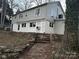 Back exterior of multi-level home featuring a stone foundation and stairs leading up to the yard at 424 20Th Ne Ave, Hickory, NC 28601