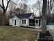 Charming home with a screened porch and manicured landscaping, set against a backdrop of mature trees at 424 20Th Ne Ave, Hickory, NC 28601