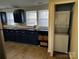 Stylish kitchen showcasing dark blue cabinets, butcher block countertops, and a convenient laundry closet at 424 20Th Ne Ave, Hickory, NC 28601