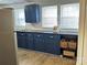 Modern kitchen with dark blue cabinets, butcher block countertops, and open shelving at 424 20Th Ne Ave, Hickory, NC 28601