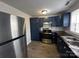 This kitchen features new stainless steel appliances, blue cabinets, and hardwood floors at 424 20Th Ne Ave, Hickory, NC 28601