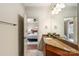 Bathroom featuring granite counters, updated fixtures, and a view to the adjacent bedroom at 425 Gladelynn Way, Waxhaw, NC 28173