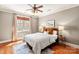 Comfortable bedroom with a ceiling fan, large window, and stylish hardwood floors at 425 Gladelynn Way, Waxhaw, NC 28173