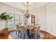 Dining room featuring a chandelier, large windows, and an adjacent entryway at 425 Gladelynn Way, Waxhaw, NC 28173