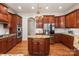 Gourmet kitchen features a central island, stainless steel appliances, and custom cabinetry at 425 Gladelynn Way, Waxhaw, NC 28173