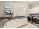 Functional laundry room with granite countertops, ample cabinet space, and stainless steel appliances at 425 Gladelynn Way, Waxhaw, NC 28173