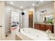 A view from the tub of the main bathroom toward the bedroom at 425 Gladelynn Way, Waxhaw, NC 28173