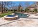 A closer aerial view of the luxurious backyard pool, hot tub, and travertine patio area at 425 Gladelynn Way, Waxhaw, NC 28173