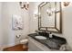 Chic powder room featuring a marble countertop, elegant mirror, and stylish lighting fixtures at 425 Gladelynn Way, Waxhaw, NC 28173