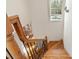 Staircase featuring wood treads, decorative wrought iron railing, and natural light at 425 Gladelynn Way, Waxhaw, NC 28173