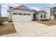 Charming gray home with a two-car garage and beautiful landscaping at 4255 Wild Ridge Dr, Charlotte, NC 28215