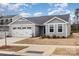 Charming gray home with a two-car garage and well-maintained lawn at 4255 Wild Ridge Dr, Charlotte, NC 28215