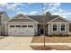 Charming gray home with a two-car garage and beautiful landscaping at 4255 Wild Ridge Dr, Charlotte, NC 28215