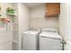 Convenient laundry room with shelving above the washer and dryer for easy storage of laundry essentials at 4255 Wild Ridge Dr, Charlotte, NC 28215