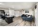 Open-concept living room featuring dark cabinets, granite countertops, and a large sofa at 4255 Wild Ridge Dr, Charlotte, NC 28215