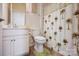 Well-lit bathroom with a vanity, toilet, palm tree shower curtain and soft rug at 427 Kentmere Ln, Lake Wylie, SC 29710