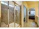 Shower enclosure featuring modern tile, a rainfall shower head, and a convenient bench at 427 Kentmere Ln, Lake Wylie, SC 29710