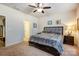 Relaxing bedroom with a queen-sized bed, soft carpet, and a ceiling fan at 427 Kentmere Ln, Lake Wylie, SC 29710