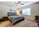 Cozy bedroom with a comfortable queen-sized bed, carpet, and a ceiling fan at 427 Kentmere Ln, Lake Wylie, SC 29710