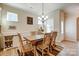 Light and airy dining room with hardwood floors, a rustic wood table, and a stylish chandelier at 427 Kentmere Ln, Lake Wylie, SC 29710