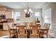 Bright dining room featuring wood floors, lots of windows, a chandelier and seating for six at 427 Kentmere Ln, Lake Wylie, SC 29710