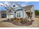 Charming house featuring blue siding, black shutters, and beautiful landscaping at 427 Kentmere Ln, Lake Wylie, SC 29710