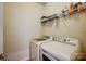 Neat laundry room with a washer and dryer set, and storage shelving at 427 Kentmere Ln, Lake Wylie, SC 29710