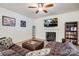 Inviting living room featuring a fireplace, flat screen television, and comfortable oversized ottoman at 427 Kentmere Ln, Lake Wylie, SC 29710