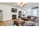 Cozy living room with a fireplace, large sectional, and stylish decor at 427 Kentmere Ln, Lake Wylie, SC 29710