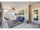 Relaxing screened porch with outdoor seating and ceiling fan, perfect for leisure at 427 Kentmere Ln, Lake Wylie, SC 29710