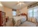 This cozy bedroom features carpet flooring, a ceiling fan, and two windows at 4840 Autumn Leaf Ln, Charlotte, NC 28277