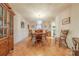 Formal dining room featuring a chandelier, hardwood floors, and a classic dining set at 4840 Autumn Leaf Ln, Charlotte, NC 28277