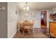 Cozy dining room with wainscoting and wood-look flooring at 4840 Autumn Leaf Ln, Charlotte, NC 28277