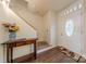 Bright foyer featuring hardwood floors, staircase, and decorative table at 4840 Autumn Leaf Ln, Charlotte, NC 28277