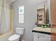 Bathroom with a toilet, shower and tub combo, and sink at 5128 Green Leaf Ct, Mount Holly, NC 28120