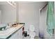 Functional bathroom features toilet, sink, shower with curtains, and ample counter space at 5128 Green Leaf Ct, Mount Holly, NC 28120
