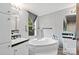 Bright bathroom showcasing garden tub, dual sinks, and large window at 5128 Green Leaf Ct, Mount Holly, NC 28120