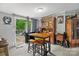 Open dining area with table, chairs, and barstool seating, plus walk-out to a back porch at 5128 Green Leaf Ct, Mount Holly, NC 28120