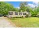 Exterior view of home with gravel driveway and front yard at 5128 Green Leaf Ct, Mount Holly, NC 28120