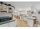 Functional kitchen with white cabinetry, essential appliances, and a cozy breakfast bar at 5128 Green Leaf Ct, Mount Holly, NC 28120