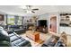 Cozy living room featuring fireplace, large tv, comfortable seating and rustic coffee table at 5128 Green Leaf Ct, Mount Holly, NC 28120