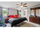 Bright main bedroom with ceiling fan, natural light, and ensuite bathroom entrance at 5128 Green Leaf Ct, Mount Holly, NC 28120