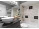 Bathroom featuring granite countertop vanity, and tiled shower and tub at 529 N Graham St # 2G, Charlotte, NC 28202
