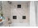 Updated bathroom featuring bathtub with marble styled tiling and black accents at 529 N Graham St # 2G, Charlotte, NC 28202
