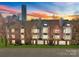 Charming multi-Gathering condo with brick accents, lush landscaping, and a cityscape backdrop at 529 N Graham St # 2G, Charlotte, NC 28202