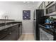 Close-up view of modern kitchen with stainless steel appliances and tile flooring at 529 N Graham St # 2G, Charlotte, NC 28202