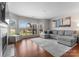 Beautifully lit living room with fireplace and view of green space beyond the large window at 529 N Graham St # 2G, Charlotte, NC 28202