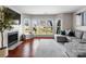 Bright living room showcasing the fireplace, natural light, and comfortable sectional sofa with throw pillows at 529 N Graham St # 2G, Charlotte, NC 28202